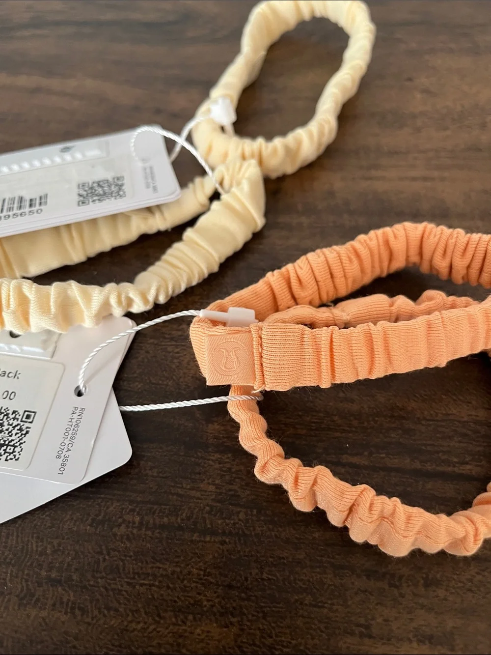 lululemon athletica Skinny Scrunchie Lot in melon and a cream color